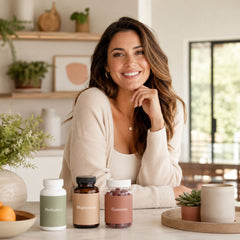 Smiling brunette seated with popular probiotics, magnesium and wellness gummies