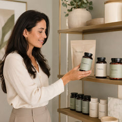 Woman browsing a shelf of magnesium, probiotics, gummies and other wellness supplements