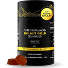 A black cylindrical bottle of Pure Himalayan Shilajit Gold Gummies with a yellow circular badge and two brown gummies placed in front on a white background.